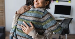 A close up of a couple hugging one another while smiling. Learn how premarital counseling in Phoenix, AZ can support your relationship’s foundation. Contact a premarital counselor in Phoenix, AZ to learn more today.