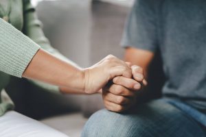 A close up of a person holding anothers hand in support. Learn more about the support an EMDR therapist in Phoenix, AZ can offer by searching trauma therapy in Arcadia, AZ today. EMDR therapy in Phoenix, AZ can offer many benefits.