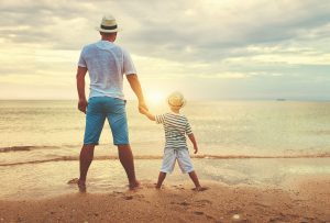 A father holds their child's hand while standing on a shore. A parenting counselor in Arcadia, AZ can offer support in cultivating your relationship. Learn more about counseling for parents in Phoenix, AZ, attachment parenting in Phoenix, AZ, and more. 